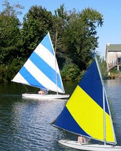 Two Sunfish with custom sails